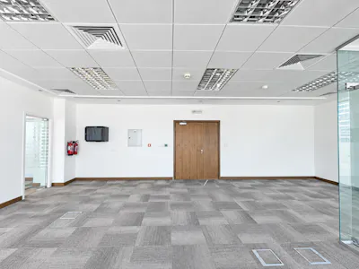 Liberty House, Dubai International Financial Centre (DIFC), Dubai, Office To Let - Modern Office Interior with Centered Wooden Door.png