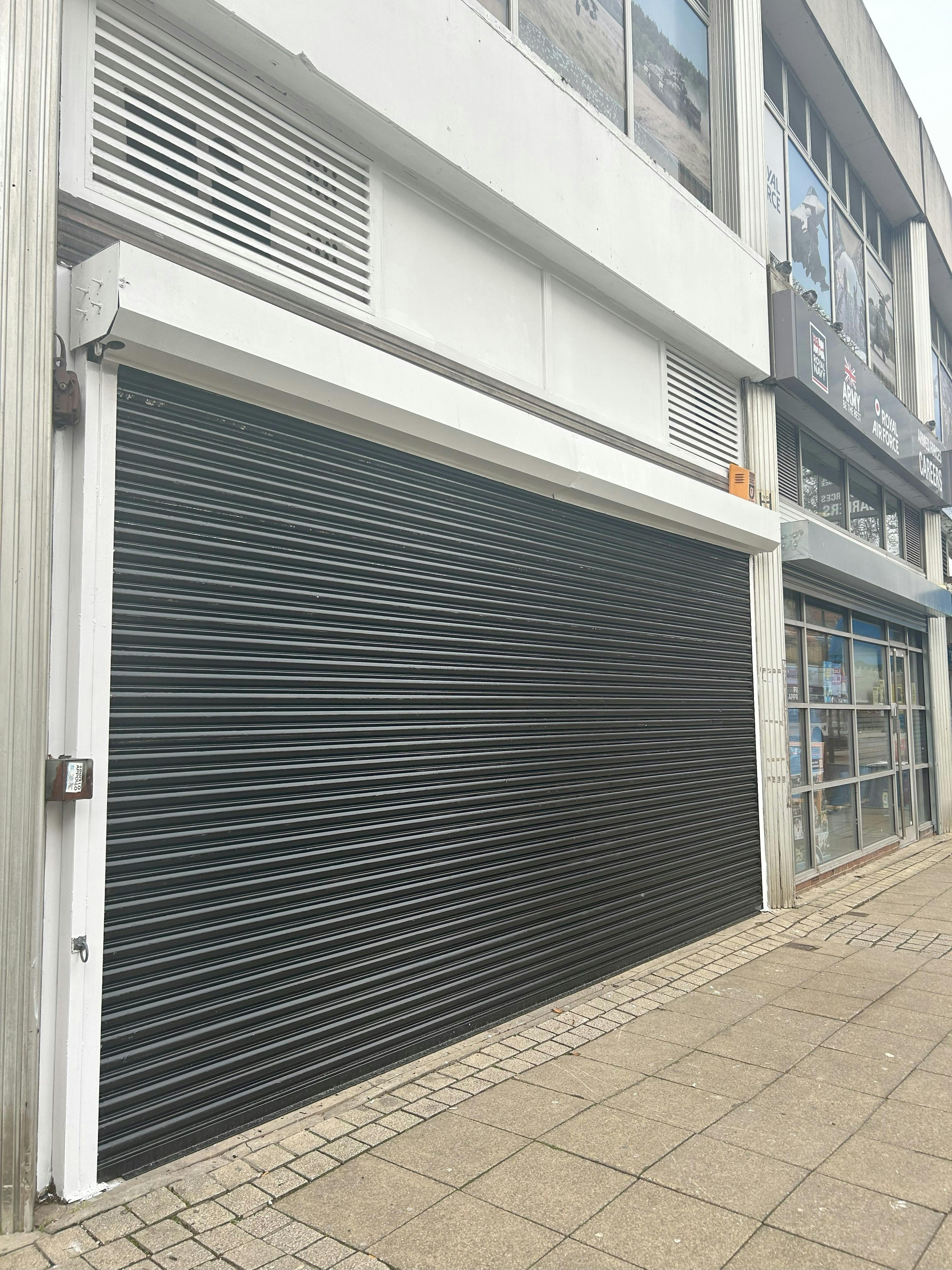 Unit 20 Hereward, Midgate, Peterborough, Retail To Let - Roller shutter .jpeg