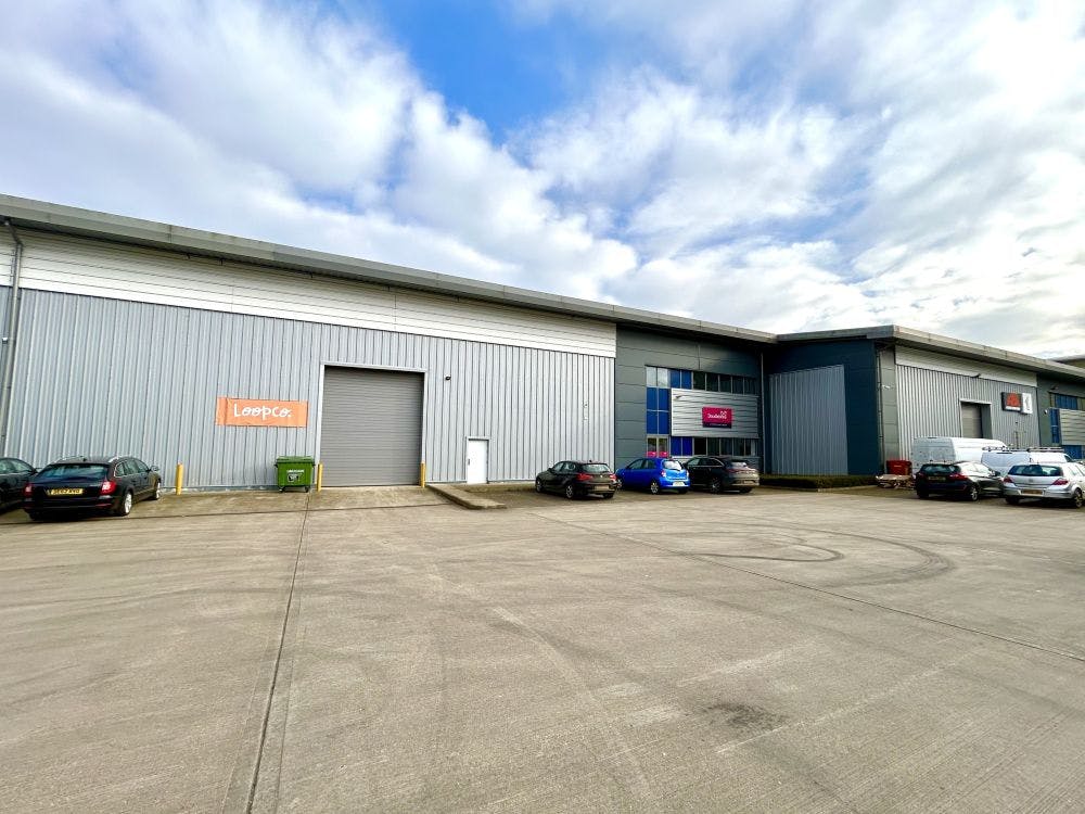 The accommodation comprises a quality industrial/warehouse space with separate ground floor offices, together with kitchenette and WC. The property benefits from a large dedicated service yard area and 14 car parking spaces. 

The terrace, comprising three units, is constructed around a steel portal frame with reinforced concrete slab that has a power floated finish with 35kN / m² floor loading capacity. There is a clear internal height to the underside of the haunch of 8m, with an electrically operated level loading door of 6m H x 4m W.