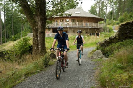 Coed Y Brenin, Dolgellau, Leisure To Let - 1961_Couple riding out from the visitor centre on the family trail at Coed y Brenin_Natural Resources Wales_No Restrictions_n_a.jpg