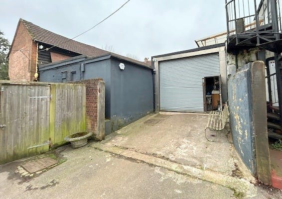 Side of 38 to 40 High Street, Bagshot, Industrial / Retail To Let - Loading bay and entrance 1.jpg