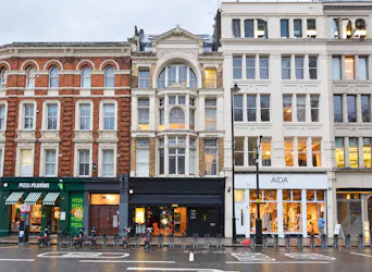 Ground Floor and Basement, 134 Shoreditch High Street, London, Retail To Let - Rainy Victorian City Block with Warm Storefronts.png - More details and enquiries about this property